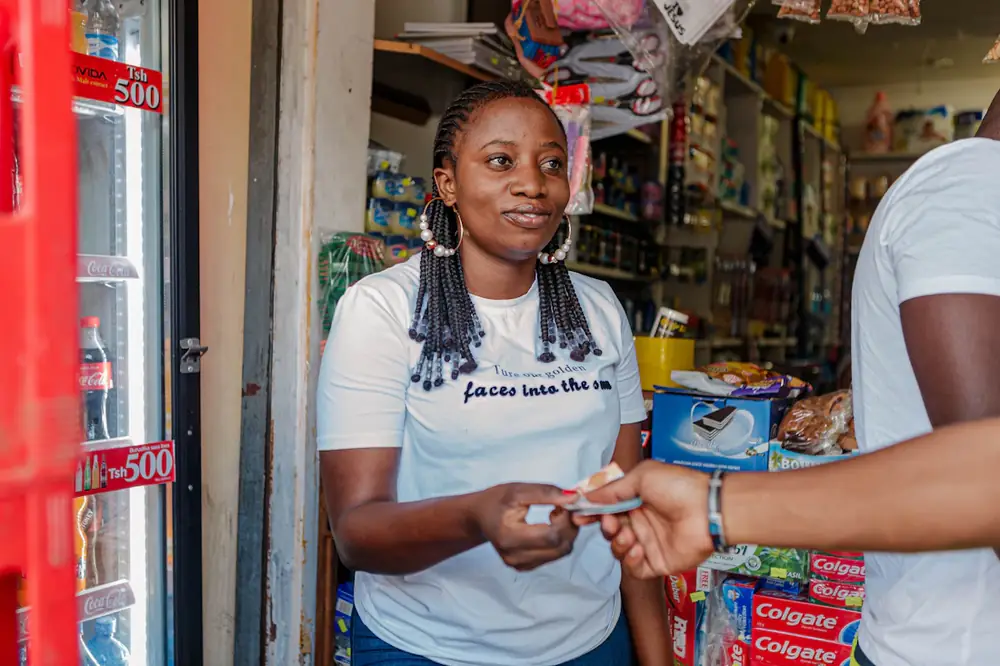 Shop owner serving a customer at her counter